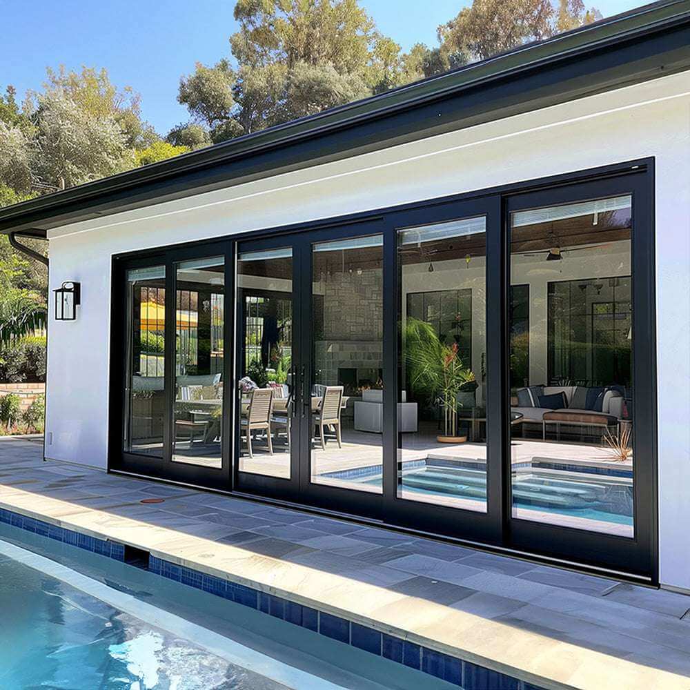30 foot wide bi-fold panoramic door opening to a modern patio by a swimming pool, showcasing sleek design.