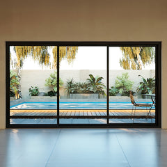 12 Foot Wide Aluminum Panoramic Sliding Door 3-Panel showcasing a view of a pool area with greenery.