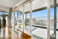 120" Wide BI-Fold Folding Door - Multiple Heights, showcasing modern design and an open view of the balcony.