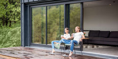 Couple enjoying drinks by the 6 Foot Wide Sliding 2-Panel Panoramic Door (Multiple Heights) in a modern home.