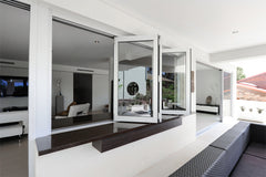 60" Wide Bi-Fold Pass Through Window - Multiple Heights opened in a modern indoor-outdoor living space.