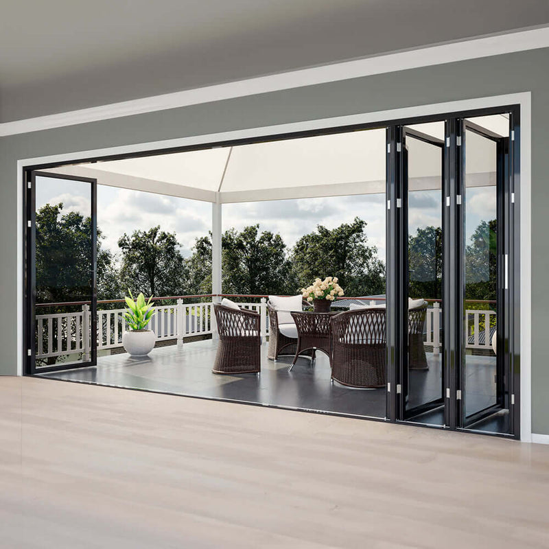 30-foot wide bi-fold panoramic glass door opening to a patio with a modern seating area and greenery outside.